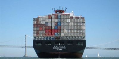 Shipping containers stacked on a ship leaving San Francisco Bay